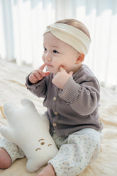 Baby wearing Avauma Ash Beige ribbed cardigan with floral baby pants, cozy infant outfit with headband